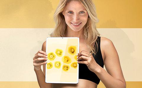 blond lady holding illustration of cells